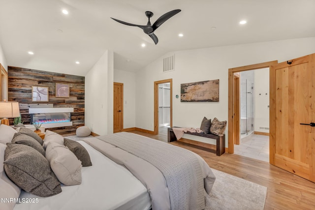 116 Cypress Way, Stateline, NV 89449 - bedroom with vaulted ceiling, wooden walls, light wood-style flooring, an accent wall, and recessed lighting