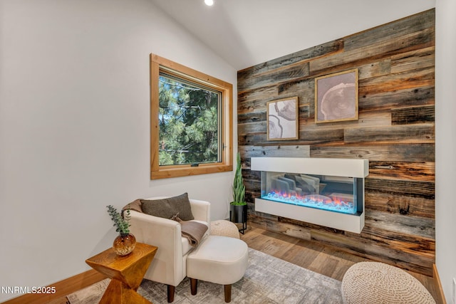 116 Cypress Way, Stateline, NV 89449 - living area featuring lofted ceiling, a glass covered fireplace, wood walls, wood finished floors, and recessed lighting
