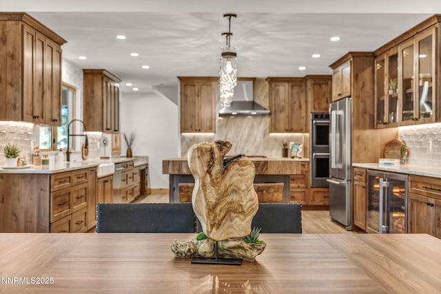 116 Cypress Way, Stateline, NV 89449 - kitchen with wall chimney exhaust hood, wine cooler, recessed lighting, stainless steel appliances, and brown cabinetry