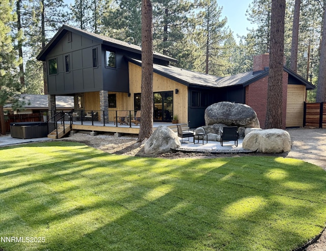 116 Cypress Way, Stateline, NV 89449 - view of front of house with a hot tub, a chimney, a patio, and a wooden deck