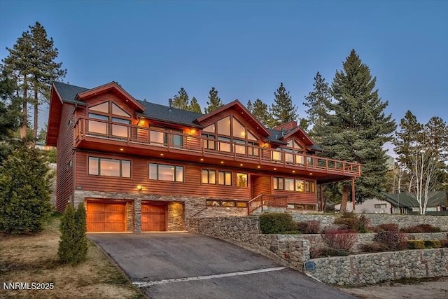 606 Jerry Dr, Zephyr Cove, NV 89448 - view of front facade with a balcony, driveway, a garage, and stone siding