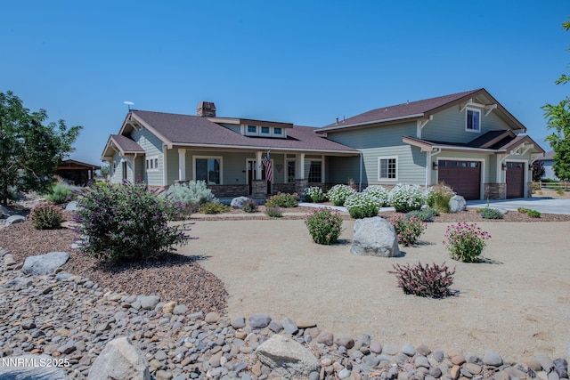 1725 Grandview Pkwy, Minden, NV 89423 - craftsman house featuring stone siding, a porch, a chimney, driveway, and a garage