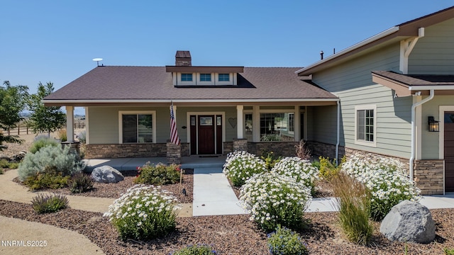 1725 Grandview Pkwy, Minden, NV 89423 - craftsman house with stone siding, a chimney, a porch, a garage, and roof with shingles