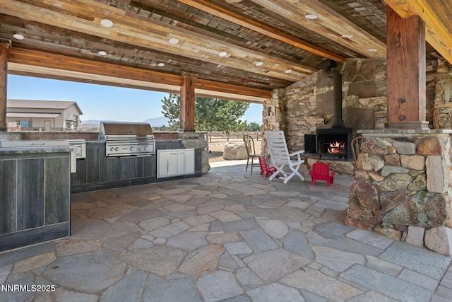 1725 Grandview Pkwy, Minden, NV 89423 - view of patio / terrace with a warm lit fireplace and area for grilling