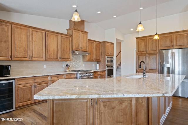 1725 Grandview Pkwy, Minden, NV 89423 - kitchen with wine cooler, dark wood finished floors, stainless steel appliances, brown cabinets, and vaulted ceiling