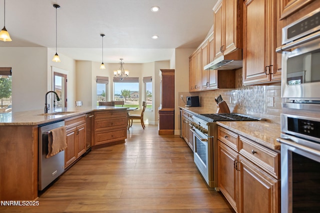 1725 Grandview Pkwy, Minden, NV 89423 - kitchen featuring appliances with stainless steel finishes, light wood-style flooring, decorative backsplash, a chandelier, and recessed lighting