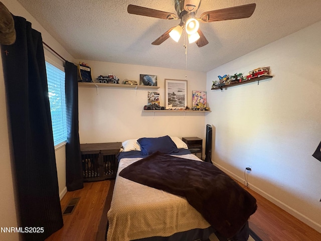 5045 Offenhauser Dr, Winnemucca, NV 89445 - bedroom with a textured ceiling, wood finished floors, and ceiling fan