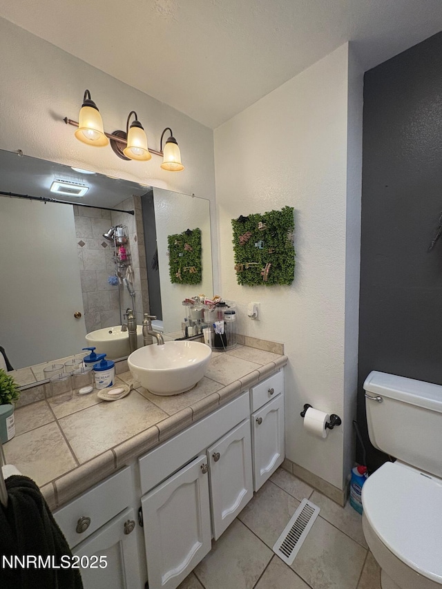 5045 Offenhauser Dr, Winnemucca, NV 89445 - full bathroom with vanity, a tile shower, and tile patterned flooring