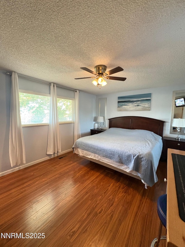 5045 Offenhauser Dr, Winnemucca, NV 89445 - bedroom with a textured ceiling, wood finished floors, and a ceiling fan