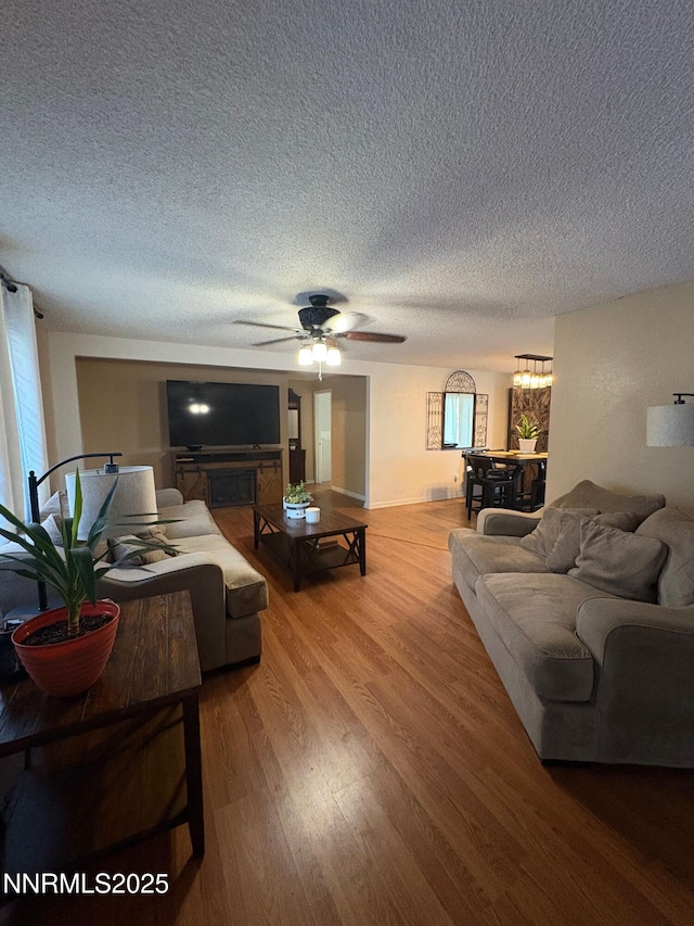 5045 Offenhauser Dr, Winnemucca, NV 89445 - living area with a textured ceiling, wood finished floors, and ceiling fan