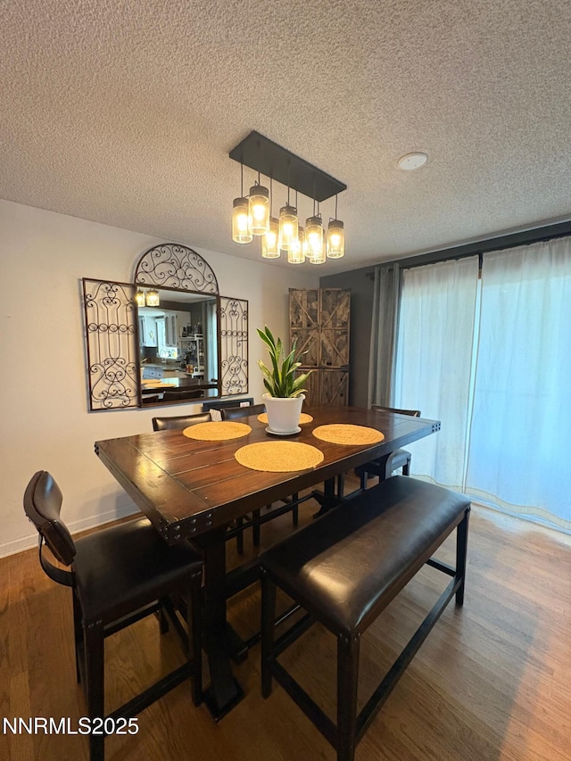 5045 Offenhauser Dr, Winnemucca, NV 89445 - dining room featuring wood finished floors and a textured ceiling