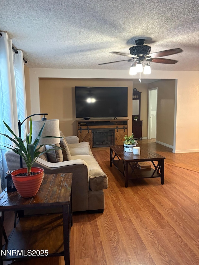 5045 Offenhauser Dr, Winnemucca, NV 89445 - living area featuring a textured ceiling, a ceiling fan, and light wood finished floors