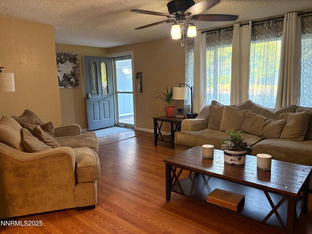5045 Offenhauser Dr, Winnemucca, NV 89445 - living area with ceiling fan, light wood-style floors, healthy amount of natural light, and a textured ceiling