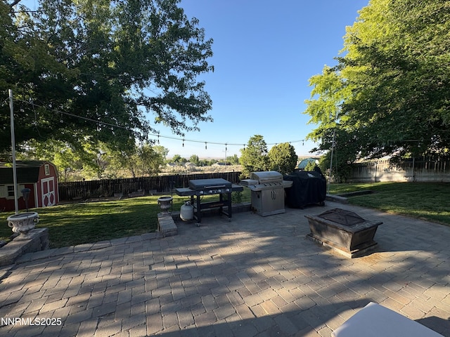 5045 Offenhauser Dr, Winnemucca, NV 89445 - fenced backyard with a patio area, a shed, and area for grilling
