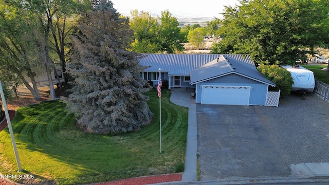5045 Offenhauser Dr, Winnemucca, NV 89445 - single story home with driveway, a garage, a metal roof, and a front lawn