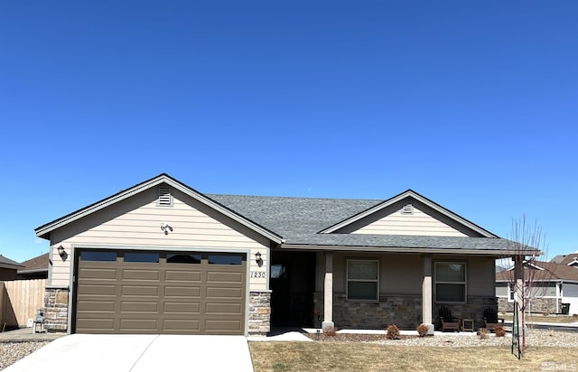 1230 W Cottage Loop, Gardnerville, NV 89460 - single story home with stone siding, an attached garage, driveway, and a porch