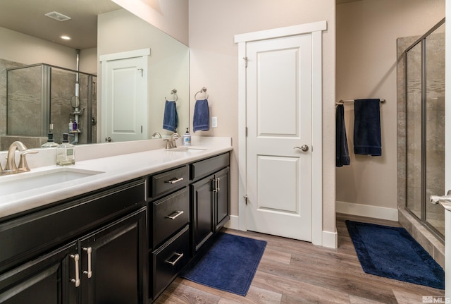 1230 W Cottage Loop, Gardnerville, NV 89460 - bathroom featuring a shower stall, double vanity, and wood finished floors