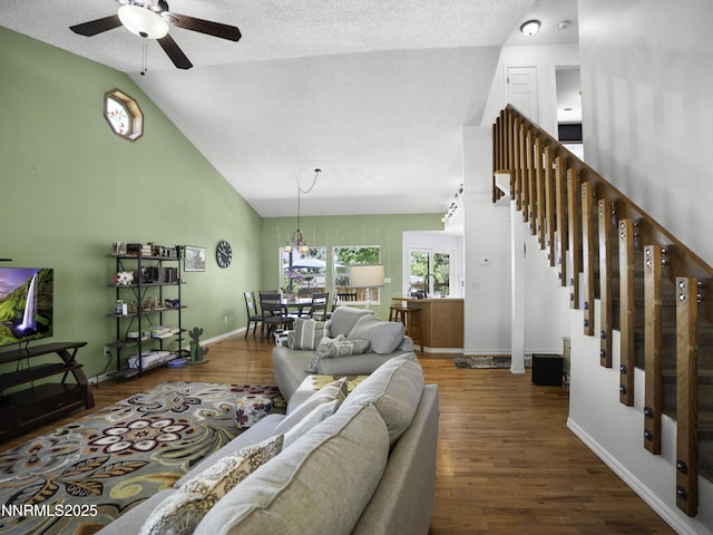1755 Mizpah St, Winnemucca, NV 89445 - living room with ceiling fan, wood finished floors, stairway, vaulted ceiling, and a textured ceiling