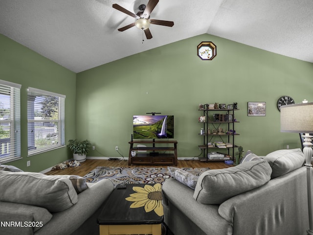 1755 Mizpah St, Winnemucca, NV 89445 - living room featuring ceiling fan, vaulted ceiling, wood finished floors, and a textured ceiling