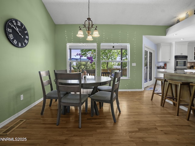 1755 Mizpah St, Winnemucca, NV 89445 - dining space featuring wood finished floors and a chandelier