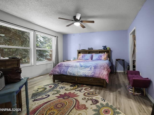 1755 Mizpah St, Winnemucca, NV 89445 - bedroom featuring wood finished floors, a textured ceiling, and a ceiling fan