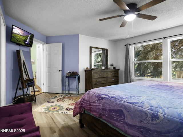 1755 Mizpah St, Winnemucca, NV 89445 - bedroom featuring wood finished floors, a textured ceiling, and ceiling fan