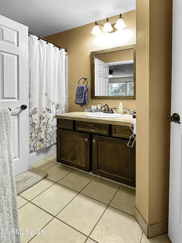 1755 Mizpah St, Winnemucca, NV 89445 - full bath featuring vanity, tile patterned flooring, curtained shower, and a textured wall