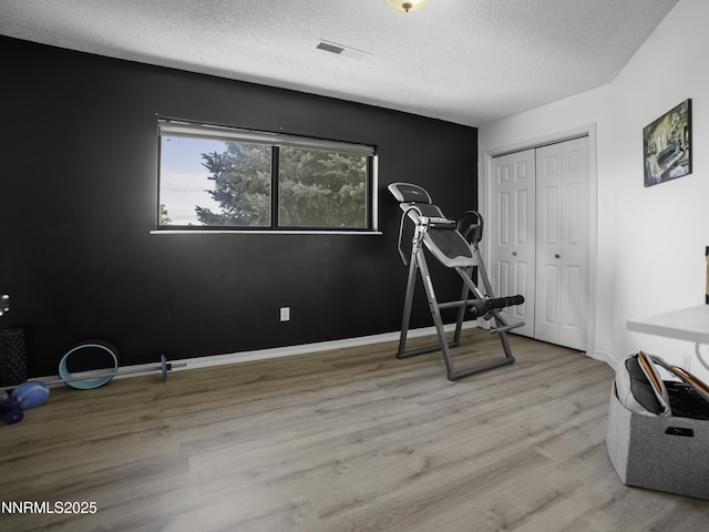 1755 Mizpah St, Winnemucca, NV 89445 - exercise area with wood finished floors and a textured ceiling