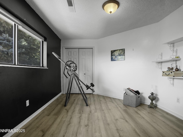 1755 Mizpah St, Winnemucca, NV 89445 - unfurnished bedroom featuring wood finished floors, a textured ceiling, and a closet