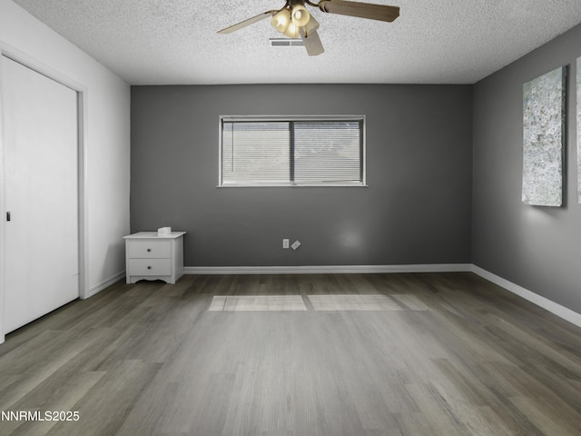 1755 Mizpah St, Winnemucca, NV 89445 - unfurnished bedroom with wood finished floors, a textured ceiling, and a ceiling fan