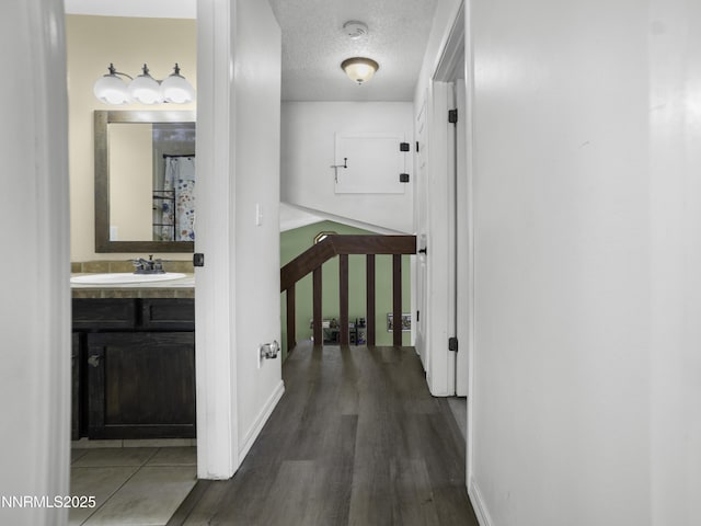 1755 Mizpah St, Winnemucca, NV 89445 - hallway featuring dark wood-type flooring and a textured ceiling