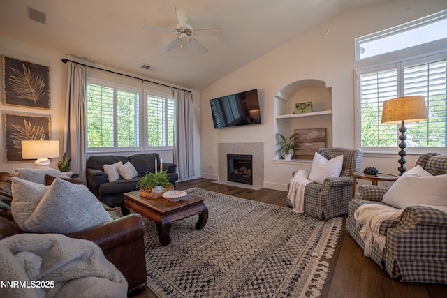 2691 Sutter Butte Ct, Sparks, NV 89436 - living area with lofted ceiling, a ceiling fan, a tile fireplace, wood finished floors, and built in shelves