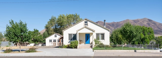 406 W 5th St, Winnemucca, NV 89445 - bungalow with stucco siding, a mountain view, and driveway