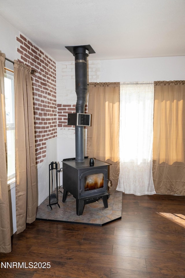 406 W 5th St, Winnemucca, NV 89445 - detailed view of a wood stove, wood finished floors, and brick wall