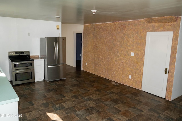 406 W 5th St, Winnemucca, NV 89445 - kitchen featuring appliances with stainless steel finishes, white cabinets, and light countertops