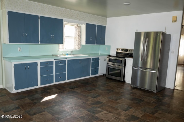 406 W 5th St, Winnemucca, NV 89445 - kitchen with blue cabinetry, appliances with stainless steel finishes, and light countertops