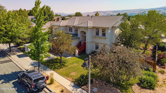 7302 Little Easy St, Sparks, NV 89436 - view of front of house with stucco siding, a mountain view, and a tile roof
