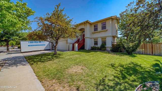 7302 Little Easy St, Sparks, NV 89436 - view of front of house with concrete driveway, a garage, and stucco siding