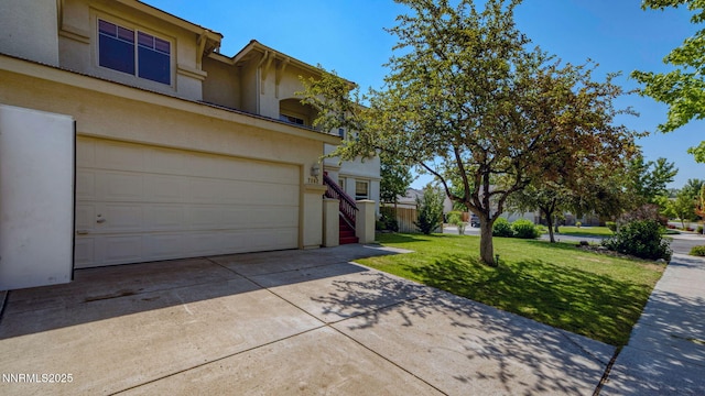 7302 Little Easy St, Sparks, NV 89436 - view of property exterior featuring driveway, stucco siding, a yard, and an attached garage