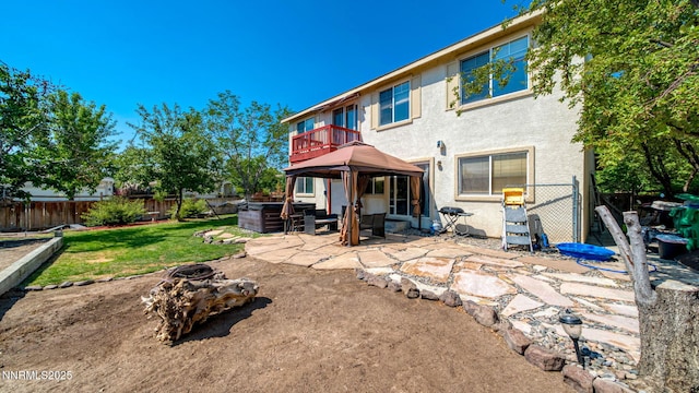 7302 Little Easy St, Sparks, NV 89436 - back of property with a patio area, a fenced backyard, an outdoor living space with a fire pit, stucco siding, and a gazebo