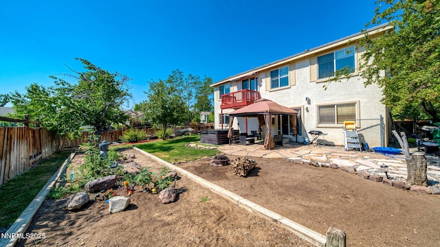 7302 Little Easy St, Sparks, NV 89436 - rear view of property featuring a jacuzzi, a patio area, a gazebo, and a fenced backyard