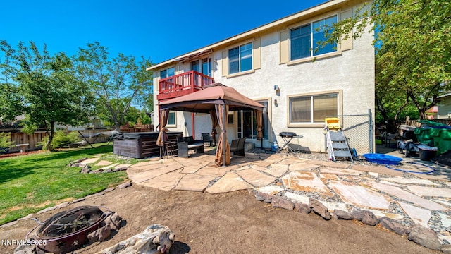 7302 Little Easy St, Sparks, NV 89436 - back of house featuring a hot tub, a patio area, a fenced backyard, stucco siding, and a gazebo