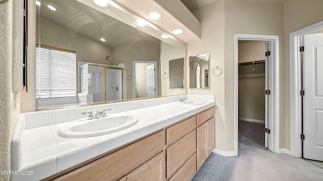 7302 Little Easy St, Sparks, NV 89436 - bathroom with a shower stall, double vanity, a spacious closet, and recessed lighting