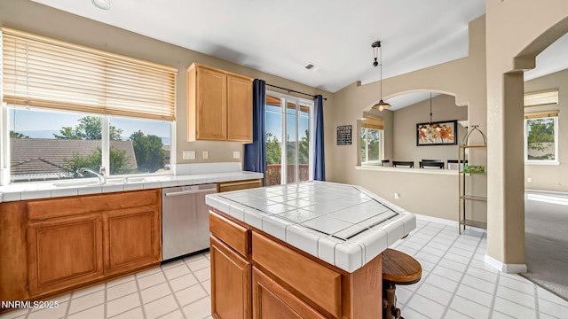 7302 Little Easy St, Sparks, NV 89436 - kitchen featuring tile countertops, light tile patterned flooring, dishwasher, lofted ceiling, and arched walkways