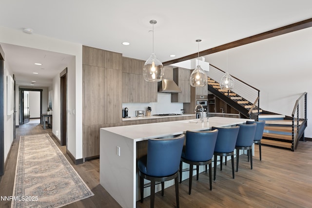 17 Beach Club Dr Unit 214, Stateline, NV 89449 - kitchen with modern cabinets, a kitchen island with sink, light countertops, a breakfast bar area, and recessed lighting
