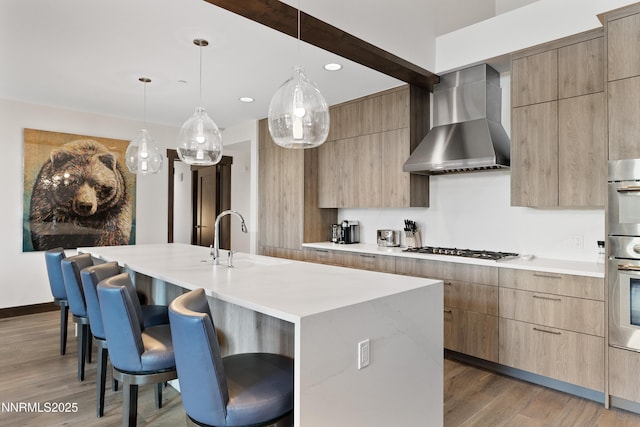 17 Beach Club Dr Unit 214, Stateline, NV 89449 - kitchen with modern cabinets, a breakfast bar area, wall chimney range hood, and recessed lighting