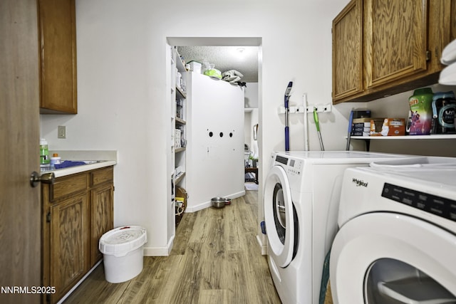 202 Summit Ave, Winnemucca, NV 89445 - washroom featuring washing machine and clothes dryer, wood finished floors, and cabinet space