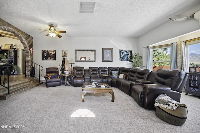 202 Summit Ave, Winnemucca, NV 89445 - living room with carpet floors, a ceiling fan, a textured ceiling, arched walkways, and stairs