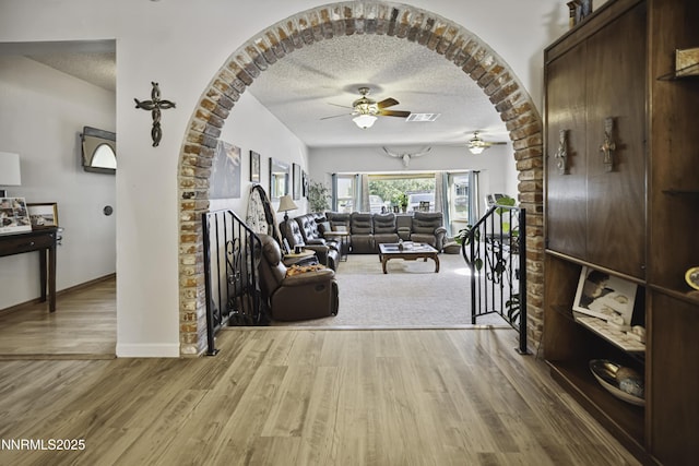 202 Summit Ave, Winnemucca, NV 89445 - foyer with a ceiling fan, a textured ceiling, wood finished floors, and arched walkways
