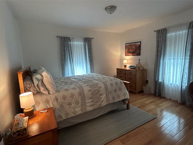 563 W 9th St, Erie, PA 16502 - bedroom featuring light wood-type flooring and multiple windows